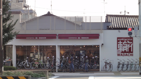 a bicycle shop with many bikes out front